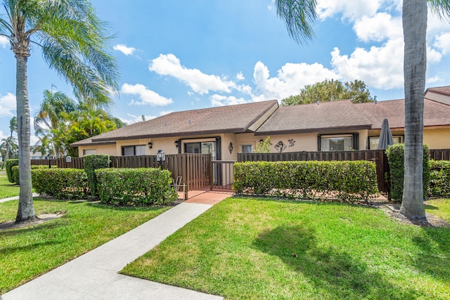 single story home featuring a front lawn