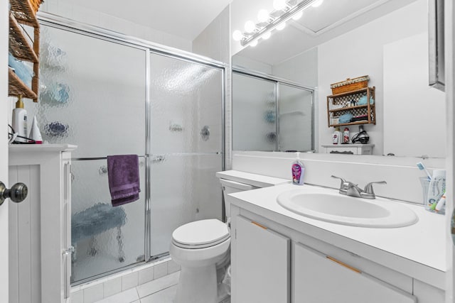 bathroom featuring a shower with door, tile patterned floors, toilet, and vanity