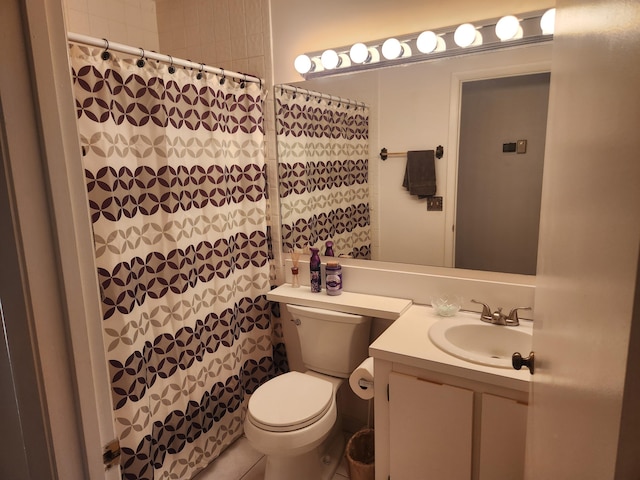 bathroom featuring toilet, vanity, and walk in shower