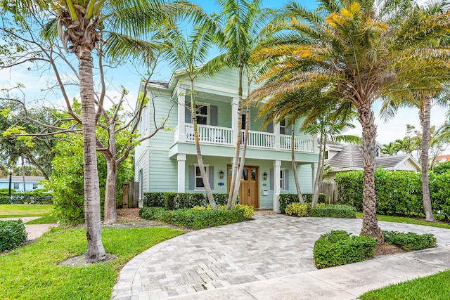 view of front of house featuring a balcony and covered porch