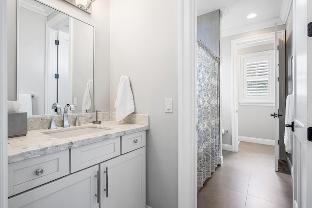 bathroom featuring ornamental molding, tile floors, and oversized vanity