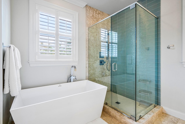 bathroom featuring a healthy amount of sunlight, tile flooring, and separate shower and tub