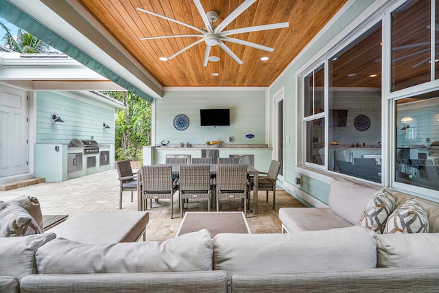 view of terrace featuring exterior kitchen, ceiling fan, and a grill