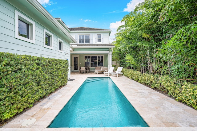 view of swimming pool with a patio and pool water feature