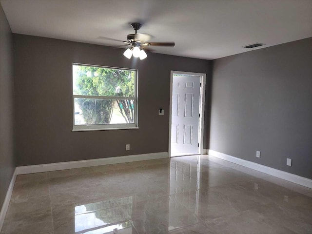 unfurnished room with tile flooring and ceiling fan