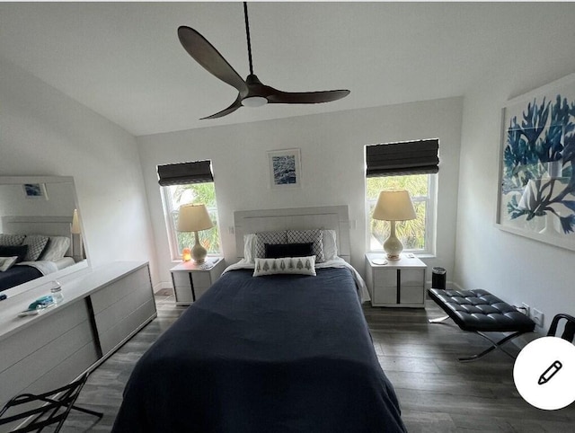 bedroom with dark hardwood / wood-style flooring, multiple windows, and ceiling fan