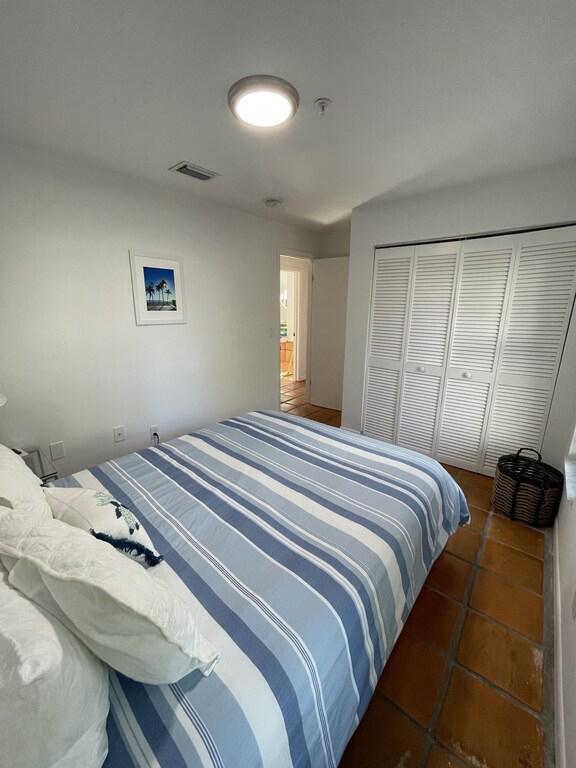 tiled bedroom featuring a closet