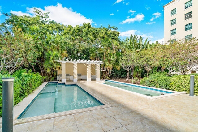 view of swimming pool with a patio and a pergola