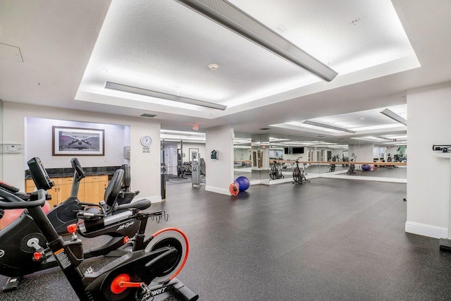 exercise room with a raised ceiling