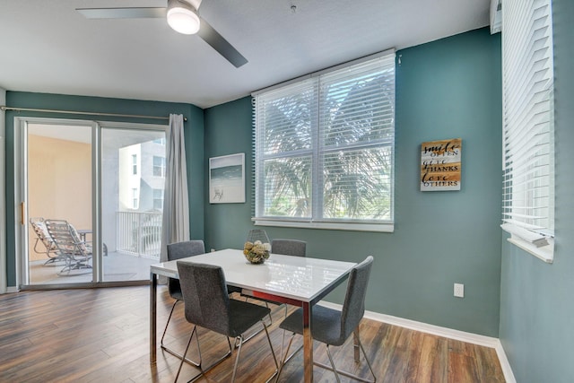 dining area with baseboards, a ceiling fan, a healthy amount of sunlight, and dark wood-style flooring