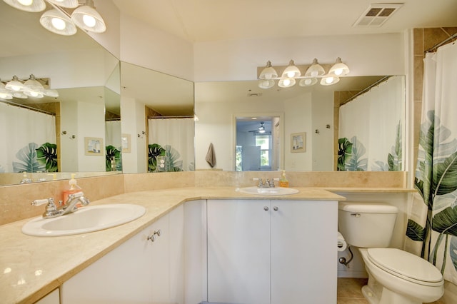 bathroom with vanity, toilet, and tile patterned flooring