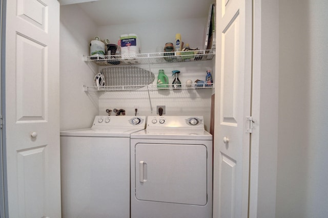 clothes washing area with washer and clothes dryer