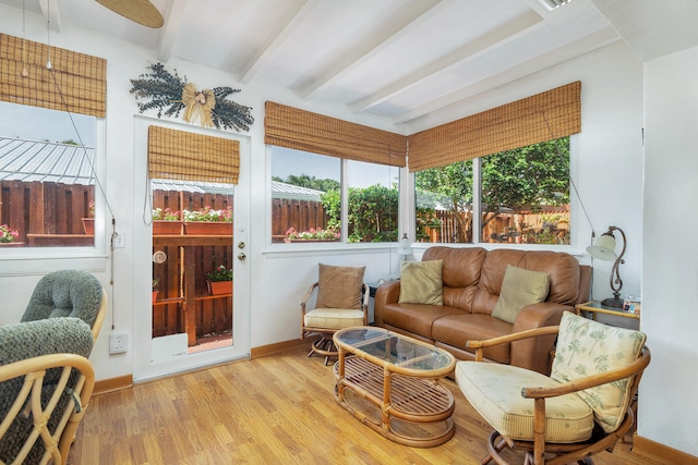 sunroom / solarium featuring beamed ceiling