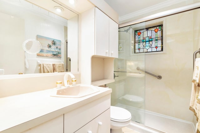 bathroom featuring a shower with door, vanity, ornamental molding, and toilet