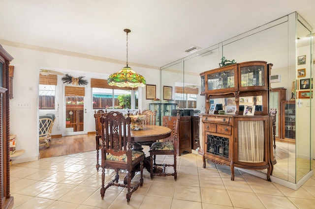 dining space with ceiling fan and light tile patterned floors