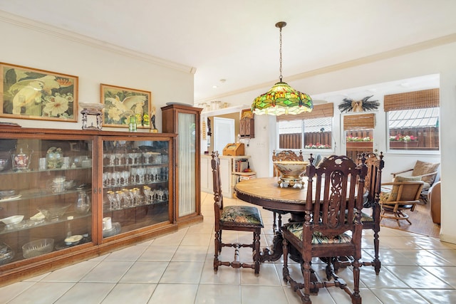 tiled dining room featuring ornamental molding