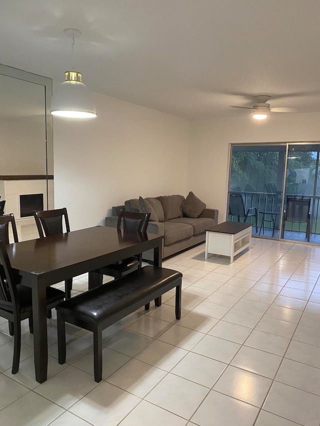 dining area with ceiling fan and light tile floors