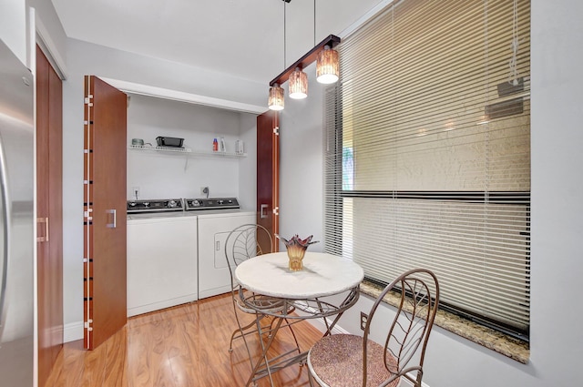 dining room with light hardwood / wood-style flooring and washer and dryer