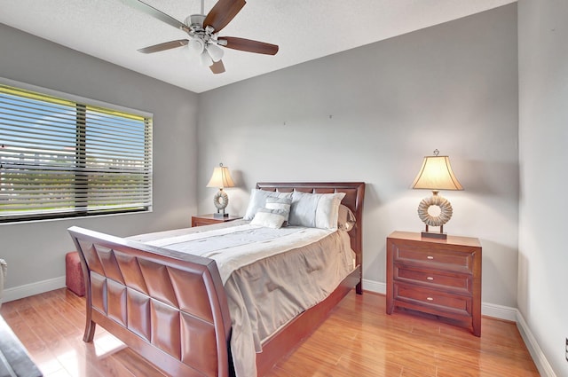 bedroom featuring light hardwood / wood-style floors and ceiling fan