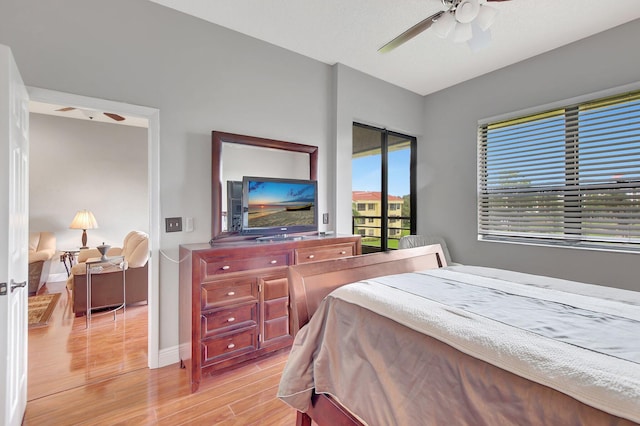 bedroom with light hardwood / wood-style floors and ceiling fan