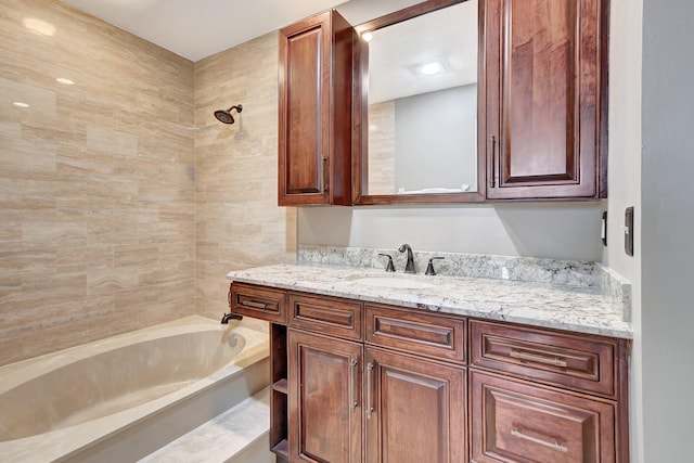 bathroom with vanity and tiled shower / bath combo