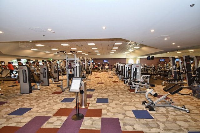 exercise room with light colored carpet