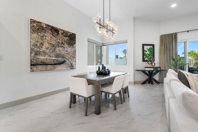 kitchen with light stone counters, white cabinets, a kitchen island, stainless steel appliances, and a breakfast bar area