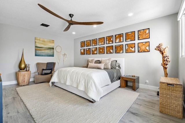 bedroom with a multi sided fireplace, multiple windows, and a textured ceiling