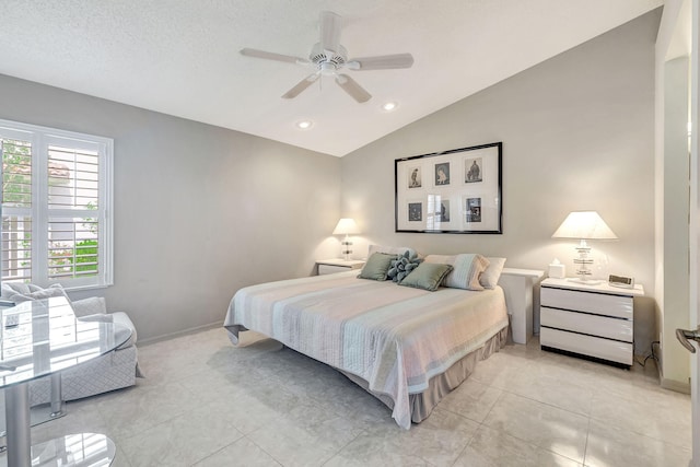 bedroom with ceiling fan, light tile floors, and lofted ceiling