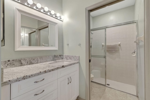 bathroom featuring oversized vanity, an enclosed shower, toilet, and tile flooring