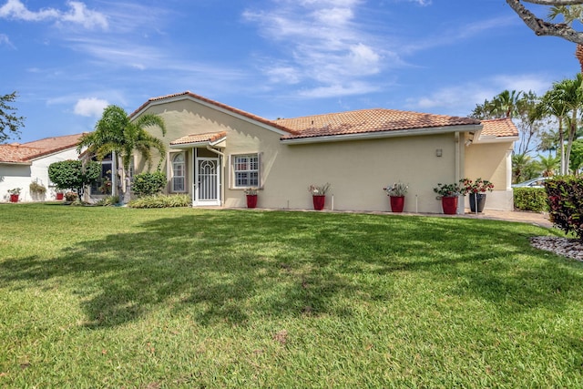 mediterranean / spanish-style house with a front lawn