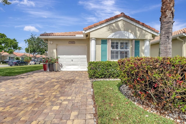 view of front of house with a garage and a front lawn