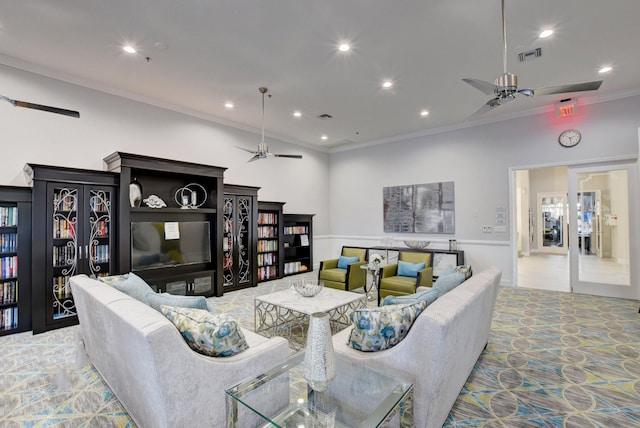 living room with ornamental molding, ceiling fan, and carpet