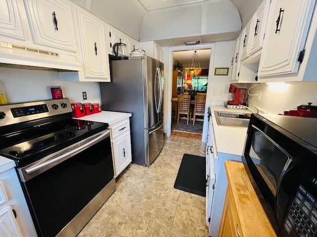 kitchen featuring custom range hood, stainless steel appliances, white cabinetry, and sink