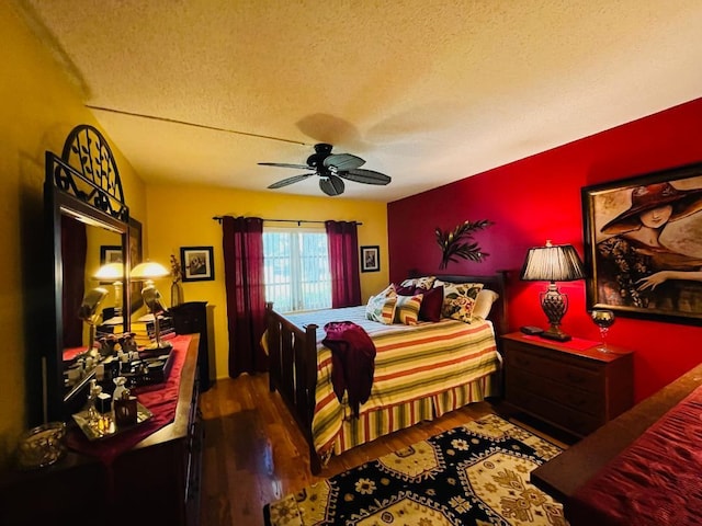 bedroom with ceiling fan, wood-type flooring, and a textured ceiling