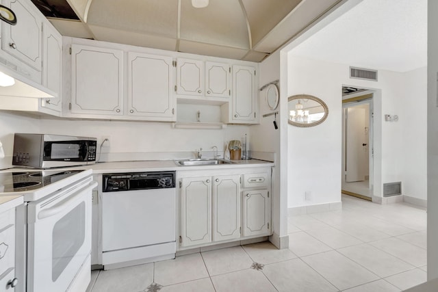 kitchen with light tile floors, range, sink, white cabinetry, and white dishwasher