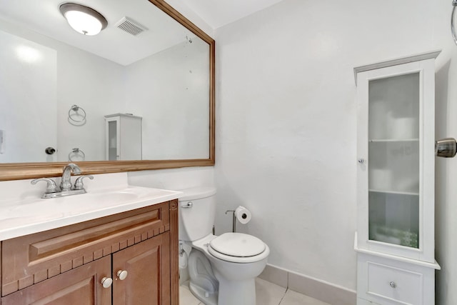 bathroom with toilet, tile floors, and vanity