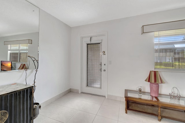 foyer featuring light tile floors