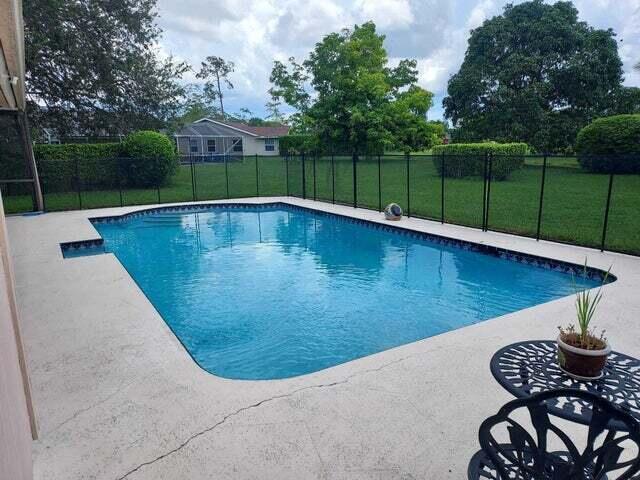 view of pool with a patio area and a lawn