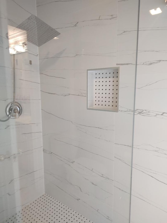 bathroom with a tile shower