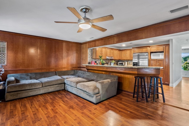 living room featuring ceiling fan and hardwood / wood-style flooring