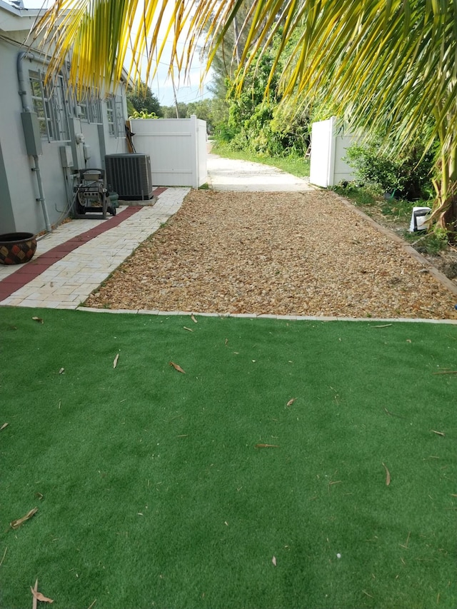 view of yard featuring cooling unit and a patio area