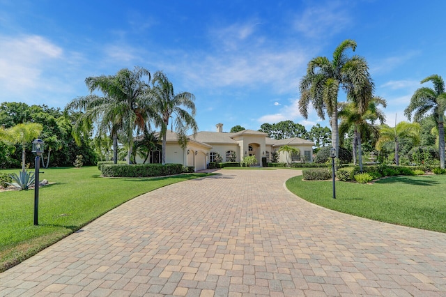 mediterranean / spanish home with a front yard