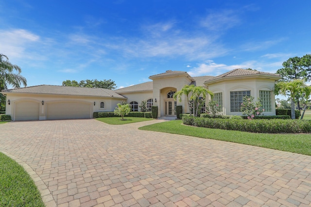 mediterranean / spanish-style home featuring a garage