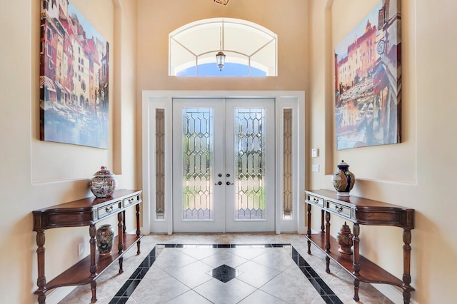 foyer entrance featuring french doors and a high ceiling