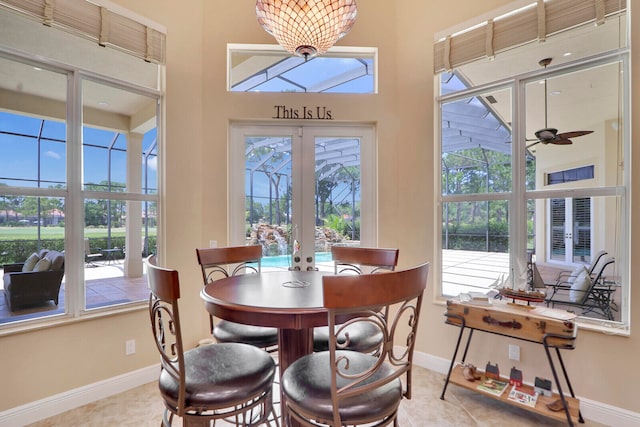 dining area with a wealth of natural light, french doors, and light tile floors