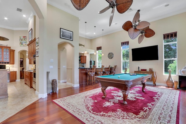 recreation room with pool table, ceiling fan, a towering ceiling, and plenty of natural light