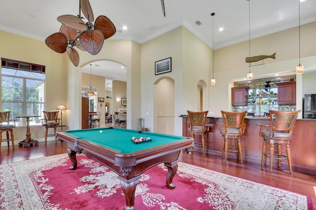 playroom with pool table, a towering ceiling, and hardwood / wood-style floors