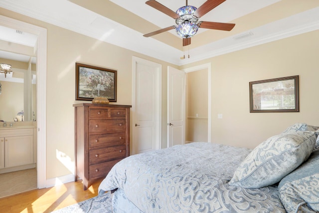 bedroom featuring ceiling fan, ensuite bathroom, sink, light tile flooring, and ornamental molding