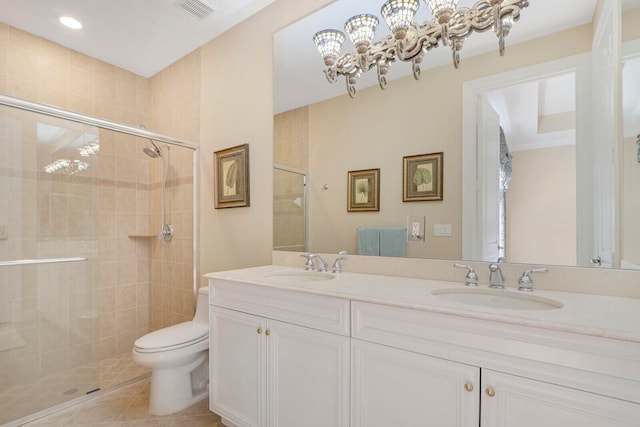 bathroom with an enclosed shower, tile floors, a notable chandelier, double sink vanity, and toilet